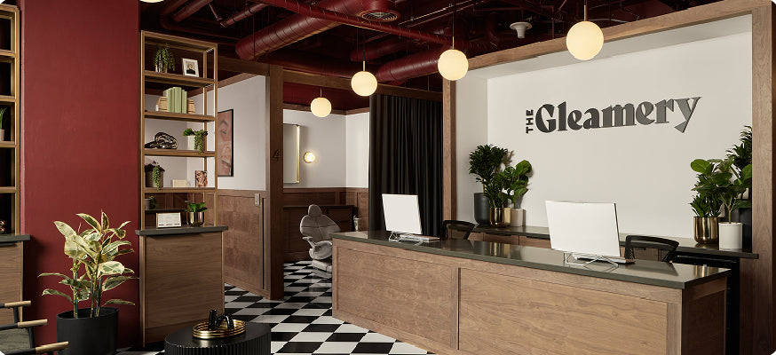 Interior of a modern office with 'The Gleamery' branding on a wall.