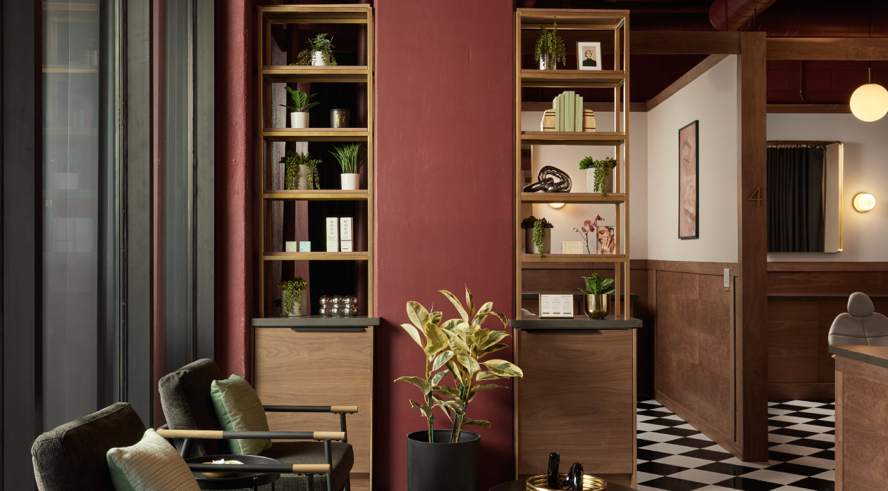 Modern interior design with wooden bookshelves, chairs, and decor elements.