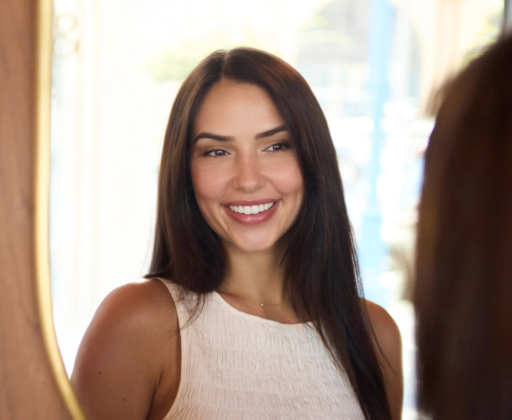Smiling woman looking in mirror